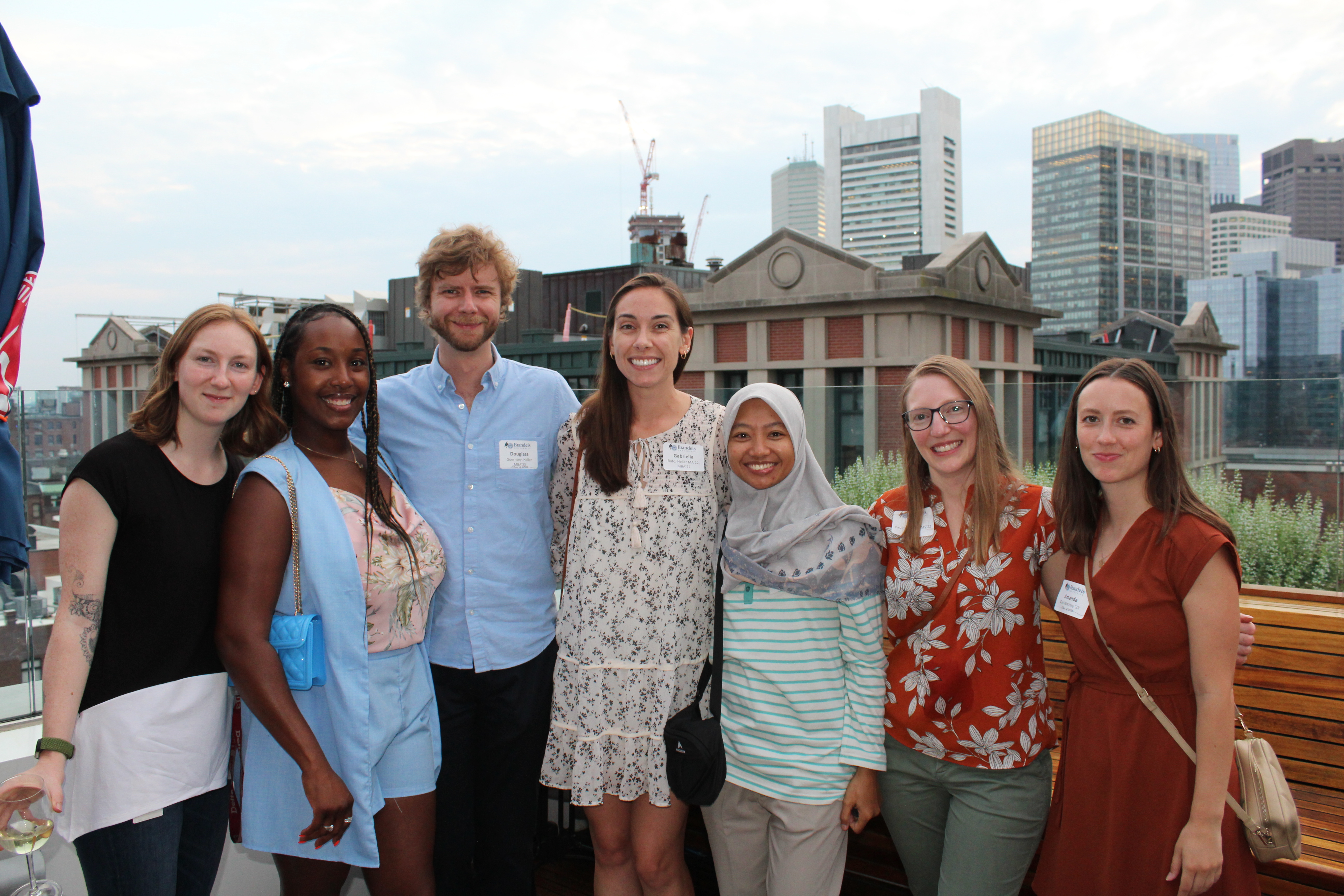 Class of 2023 Graduates posing for a photo at Boston's happy hour event